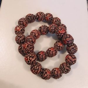 Two dragon tattooed bracelets